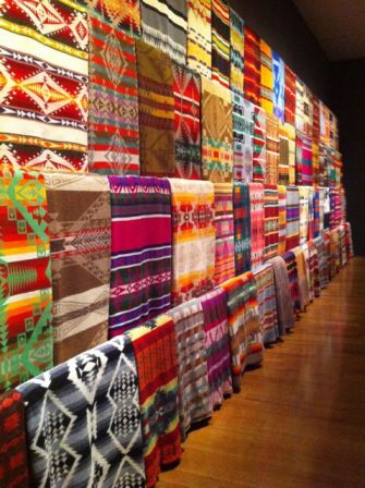 Some of Chihuly's blanket collection line the wall of the gallery.