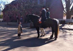 Looking up to the past.<br /><br />A young visitor finds both human and equine re-enactors equally fascinating andfriendly on Duke of Gloucester street.