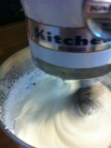 About a minute into beating the egg whites and salt. Use the whisk attachment on you mixer.