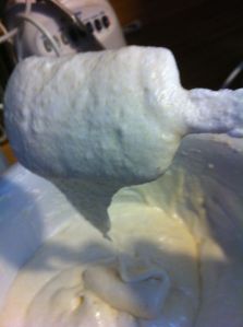 Folding the egg white mixture into the dry mixture.