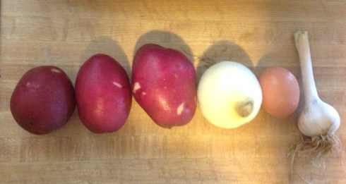 A line up of the usual suspects... Red Potatoes, Onion, Egg, and Garlic... wait to be transformed