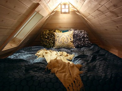 Cozy loft bedroom in the Cypress 20 lets you get in touch with your "shabby, chic, and romantic" sides, all while camping. 