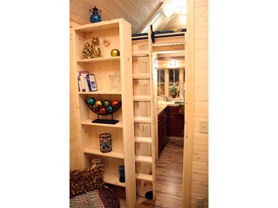 A bookshelf hides the sliding ladder that gives access to the sleeping loft in the Cypress 20. In a modern age of Kindles and Cloud storage small living becomes ever more possible. 