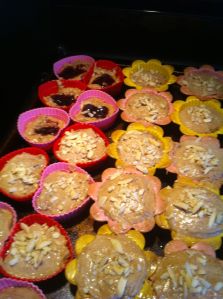 Muffins in the fore ground are complete, those in the back left have the jelly, but not the top layer of batter. 