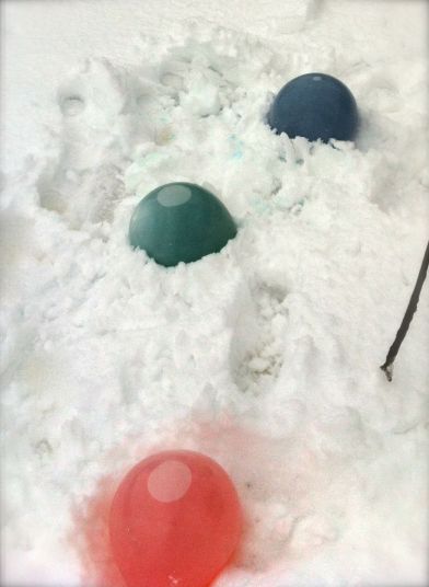 Ice marbles in the process of freezing in the snow. 