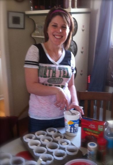 The delightful Annie expertly adds Marshmallow Fluff to the S'More Muffins, proving that many hands make light work in the kitchen.